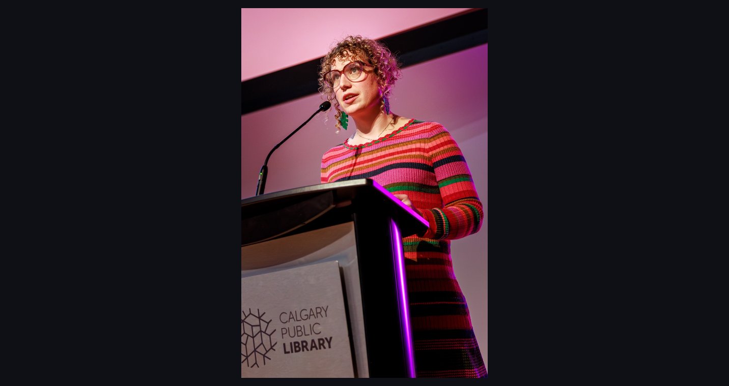 Elli McDine speaking at Calgary Public Library